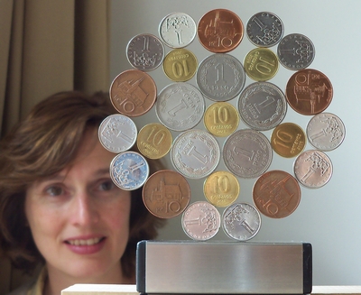 image: Standing Pentagonal Patagonia Wild Rose  Mandala of coins of  Argentina and Ceska (centre  and  r2:  10cvs 2009, r1: 1 peso 1960, r3: ceska 10k 1993-2008, 1K 1994)          
